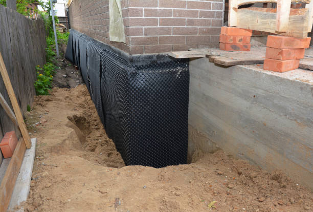 Happy homeowners after waterproofing job in Tyner